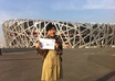 take a photo holding a handwritten sign for you standing in front of the Beijing Olympic Birds Nest Stadium small2
