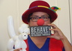dress up in a clown hat and nose holding a message and send hd pictures small2