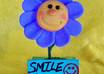 make a personalized smiling flower sculpture with a sign that has your message