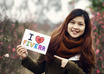 take nice pictures holding a handwritten sign of your website or business at CHERRY blossom field small1