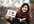 take nice pictures holding a handwritten sign of your website or business at CHERRY blossom field