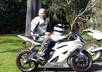 record a 30 sec video of riding a sports motorbike around the streets and stopping infront of a sign or verbal message/wishes of your choice