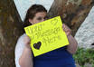 take 3 high resolution photos of my girlfriend holding a sign to promote your message small1